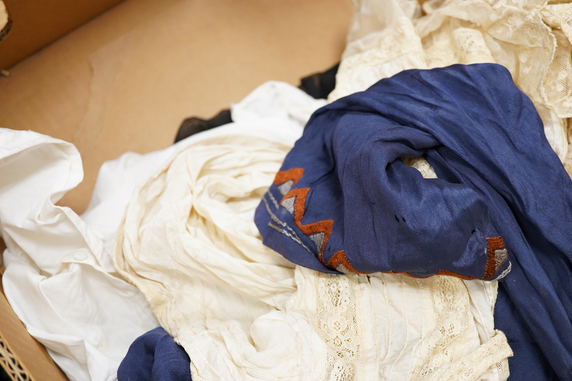 Two Edwardian blouses and three earlier lace camisoles, three black satin partly sewn skirts and later black velvet diamonte decorated evening coat. Condition - the coat, skirts and blouses need repair but are good for T